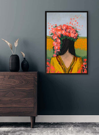 Framed "Like The First Day - Treechild" artwork showing a woman with flowers on her head, hanging in a modern room.