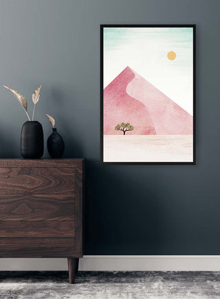 Framed Sossuvlei print by Henry Rivers featuring a pink sand dune, tree, and sun on a modern living room wall.