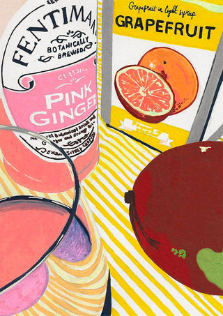 Fentimans Pink Ginger bottle with a grapefruit drink and cocktail glasses on a striped surface.