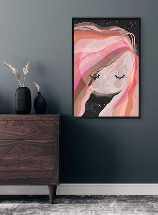 Framed Moon Girl art print with flowing pink hair displayed above a wooden dresser in a modern room.