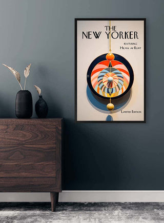 Framed New Yorker cover featuring Hilma Af Klint abstract art, displayed on a dark wall above a modern wooden dresser.