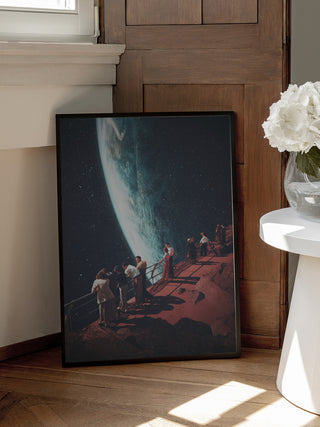 Framed "Missing the Ones We Left Behind" print by Frank Moth leaning against a wooden door.