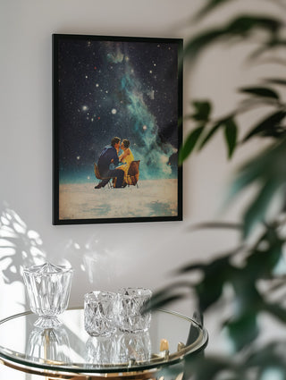 Framed "I'll Take You To the Stars for a Second Date" by Frank Moth hanging above a glass table.