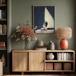 This Love - Frank Moth artwork framed above a wooden cabinet with vases, a lamp, and decorative plants.