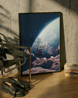 Framed "Often Mistaken for Absent" by Frank Moth leaning on wall, space-themed art with two figures and the Earth.
