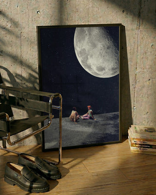 Framed "I Gave You the Moon for a Smile" by Frank Moth leaning against a wall, moon art visible.