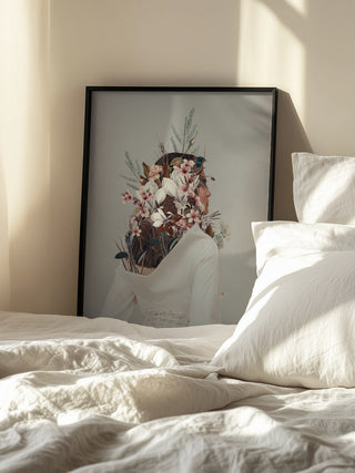 Framed "You Gifted Me an Autumn" artwork by Frank Moth resting against a wall beside a sunlit bed.