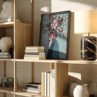 Framed "I Was Hidden but You Saw Me" by Frank Moth displayed on a wooden shelf with books and decor.