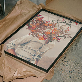 Framed Roots Bright - Frank Moth art print showing a head replaced by flowers and fruit, displayed on brown paper.