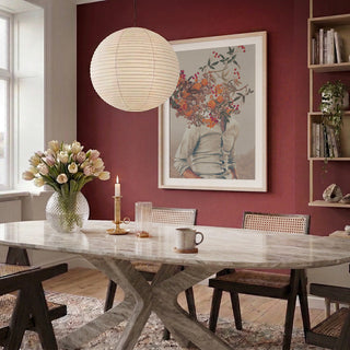 Modern dining room featuring "Roots Bright" by Frank Moth on a red wall above a table with flowers and candle.