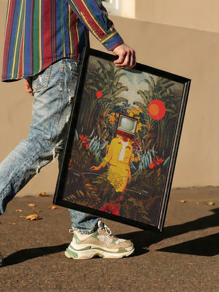 Person holding framed "She Came From the Wilderness" by Frank Moth, depicting surreal jungle art.