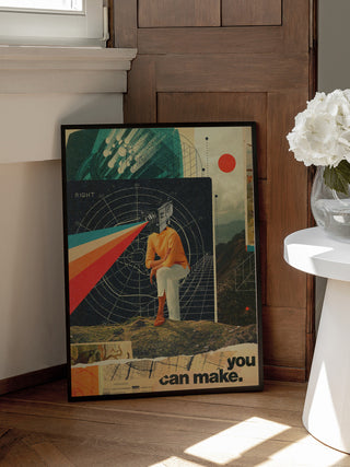 Framed "You Can Make It Right" by Frank Moth leaning against a wooden door, beside white flowers.