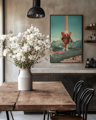 Framed "Enemy" artwork by Frank Moth displayed in a stylish dining room with wooden table and white flowers.
