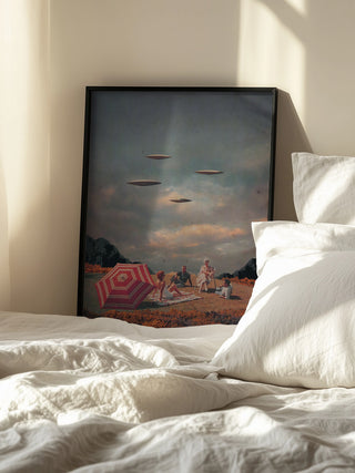 Framed print of "Pretend They Never Came" by Frank Moth resting on a bed in soft daylight.