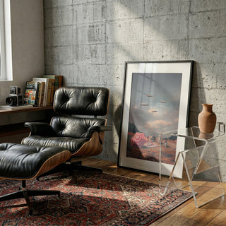 Framed "Pretend They Never Came" by Frank Moth leaning on wall in stylish reading nook with chair and rug.