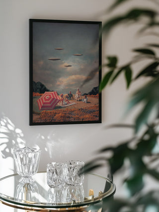 Framed "Pretend They Never Came" by Frank Moth displayed above a glass table with crystal decor.