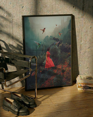 Framed "20 Seconds Before the Rain" art print by Frank Moth leaning against a wall near a chair and books.