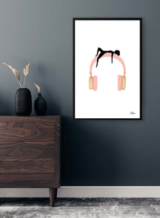 Framed Sara Sonne - Being art print with minimalist figure on pink headphones, displayed above a dark wood dresser.