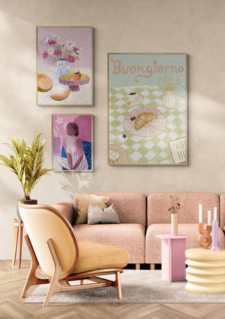Framed Buongiorno print on wall above pastel sofa, styled with modern decor and indoor plant.
