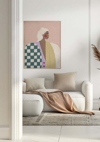 Wall art of a figure in a funky patterned blouse above a neutral sofa, displayed on the Bea Muller product page.