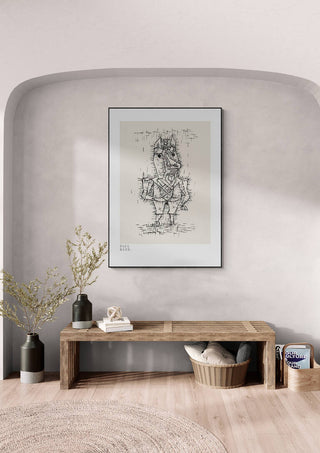 Framed print of Paul Klee’s "Ass Esel 1925" hanging above a wooden bench in a modern, minimalist room.