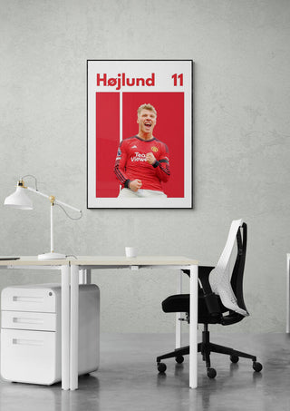 Rasmus Højlund Football Poster featuring him in a red jersey, displayed on a modern office wall.