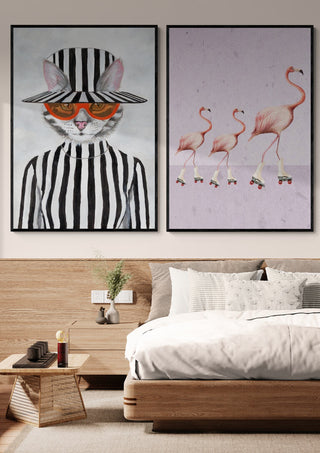 Framed artwork of a cat in striped clothes and hat, displayed above a bed on the product page for Cat in stripy mood.