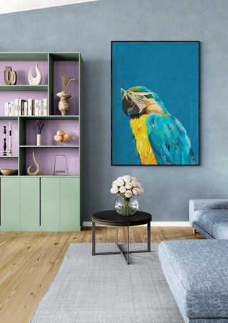 Art print of a colorful macaw wearing glasses by Sarah Manovski, displayed in a modern living room.