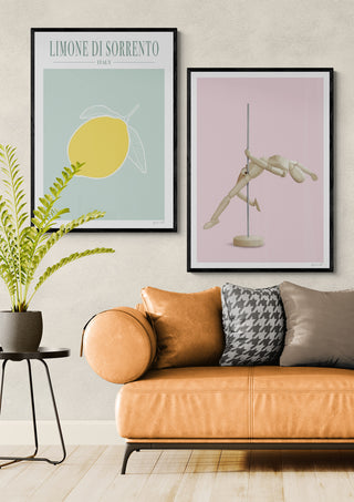 Framed Pole Dancer - ByKammille art print displayed above a modern tan sofa in a stylish living room.