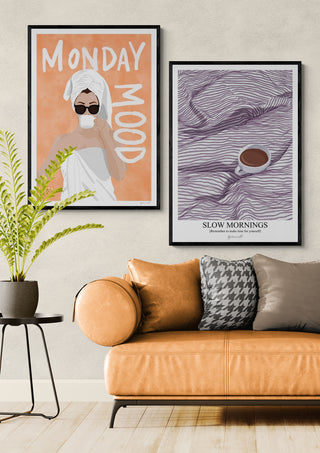 Framed "Slow Mornings - ByKammille" print featuring a coffee cup on textured lines, styled above a sofa.