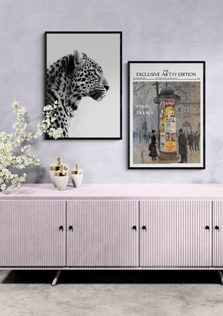 Paris News Artsy Edition print framed on wall above a modern sideboard, beside leopard artwork.