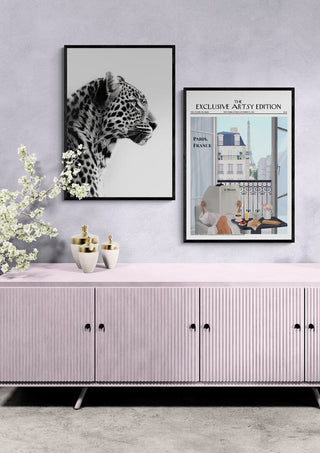 Framed Paris Coffee Artsy Edition print displayed on a wall above a pastel sideboard with decorative items.