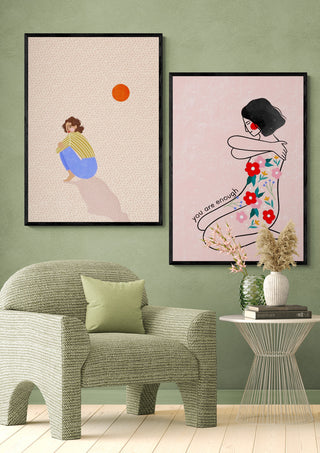 Framed "You Are Enough" art print by Bea Muller on a wall above a green chair and glass side table.