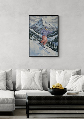 Framed art of a skier racing downhill on snowy mountains, enhancing a cozy living room setting.