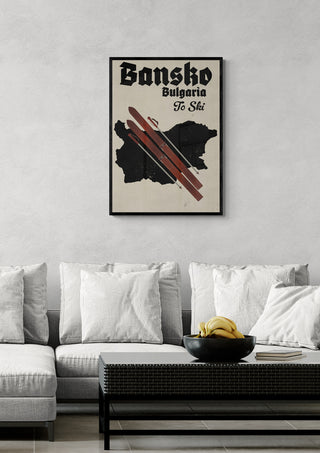 Framed "Bansko Bulgaria To Ski" poster with skis and map, displayed above a modern sofa in a living room.