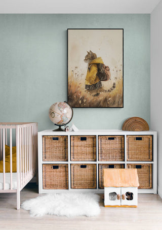 Framed Cool Cat artwork on wall above wicker storage unit in a cozy, modern nursery room.