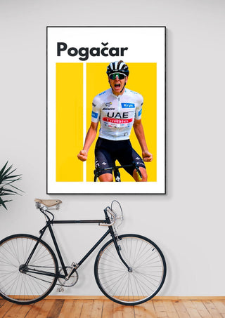 Poster of Tadej Pogačar celebrating in UAE cycling kit with yellow background, displayed above a bicycle.